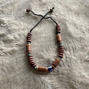 Bracelet with wooden beads and an evil eye bead in the center